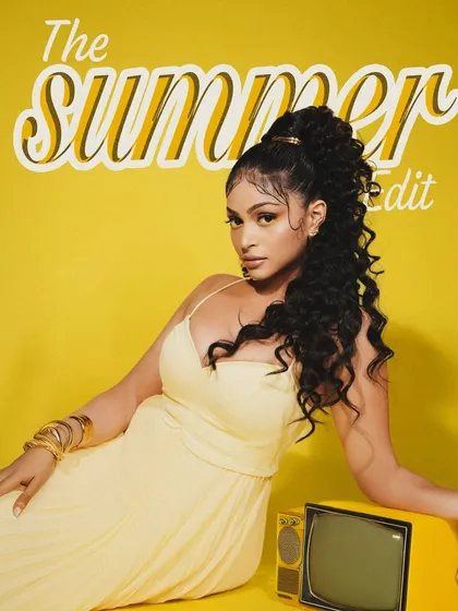 A retro-inspired shot from the "Summer Edit" campaign. The model poses with a vintage TV, blending modern makeup trends with a nostalgic, stylish aesthetic.