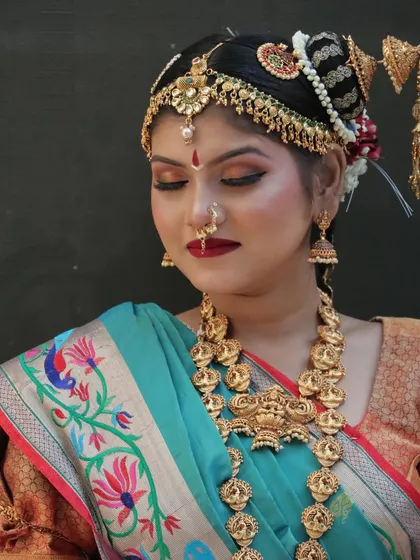 The focus here is on the warm, golden-toned eye makeup that perfectly complements the silk saree and gold jewelry.