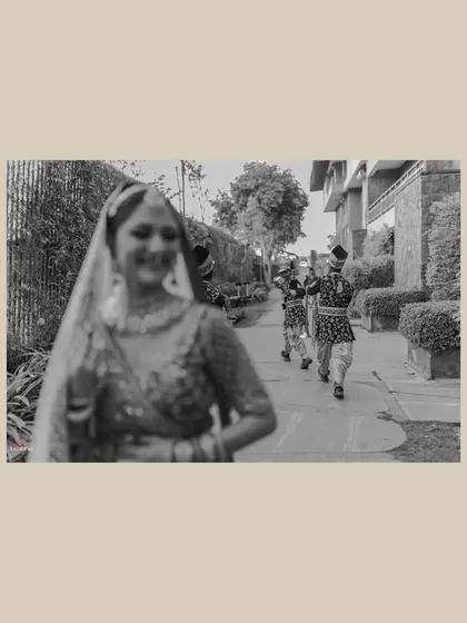 The moment the groom's procession arrives is full of anticipation. I used a creative focus technique here to capture the bride, Yashika, in the foreground, with the approaching baraat creating a sense of story and excitement.