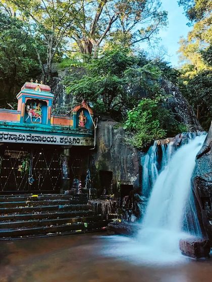 A unique waterfall that flows right beside a temple, a beautiful blend of nature and spirituality we visit.