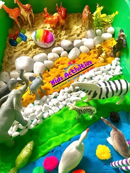 This is a snapshot of one of our sensory bins, a core part of our learning process. Here, children explore a miniature jungle world with different textures like sand, stones, and water. This kind of sensory play is vital for developing cognitive, social, and fine motor skills in a calm and engaging way.
