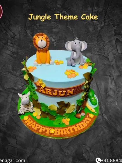A beautiful jungle-themed cake with cute, cartoonish fondant animals like a lion, elephant, and zebra. The leafy green details complete the wild look.