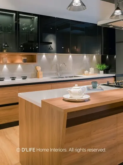 This modern kitchen features a large island with a breakfast bar, sleek black and wood cabinets, and state-of-the-art appliances. It's a perfect space for both cooking and socializing.