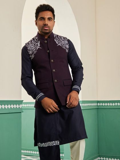 This frontal view of the space blue bundi set shows the complete look, from the detailed shoulders to the embroidered drape, perfect for a cocktail reception.