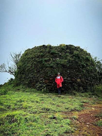 Posing next to an ancient, moss-covered structure found along the Ballalarayanadurga fort trail, on the way to Bandaje falls.