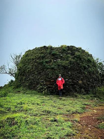 Posing next to an ancient, moss-covered structure found along the Ballalarayanadurga fort trail, on the way to Bandaje falls.