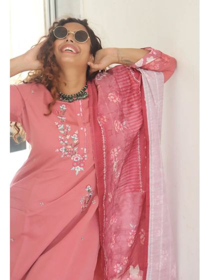 Having fun with accessories. I paired this pink embroidered suit with a statement green necklace and round sunglasses for a playful, modern-ethnic look.