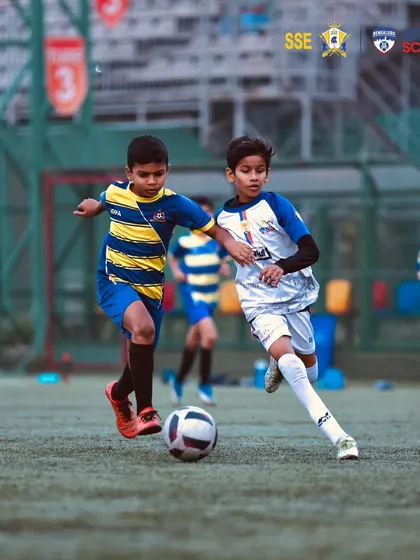 An intense duel for the ball between two young, determined players.