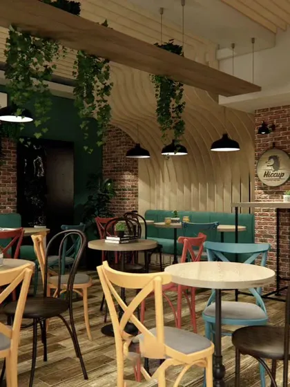 We brought an eclectic, rustic charm to this cafe with exposed brick walls, mismatched colorful chairs, and industrial pendant lighting. The design creates a vibrant and casual ambiance, encouraging social interaction and making the space feel lively and welcoming.