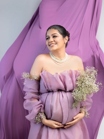 The same beautiful setup, capturing a candid moment of happiness. The genuine smile and flowing fabric create a portrait that is both elegant and full of life.