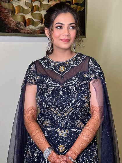 A portrait of the bride, looking confident and beautiful. The soft makeup enhances her features and complements her embellished gown.