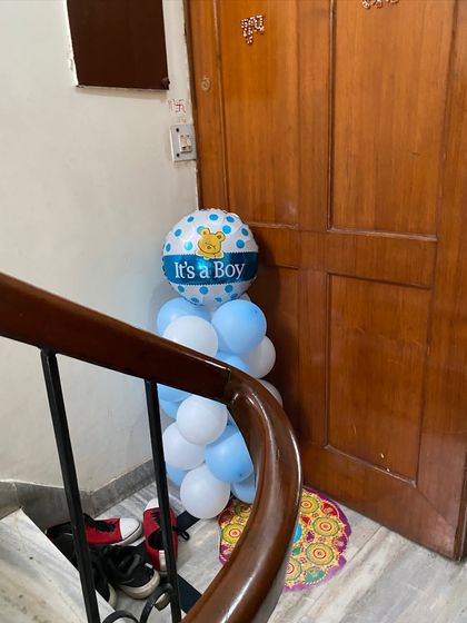 An 'It's a Boy!' balloon arrangement placed by a staircase, adding a festive touch to the entire home.