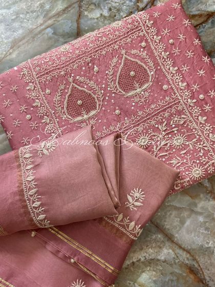 A folded view of the suit, perfect for appreciating the density of the embroidery.