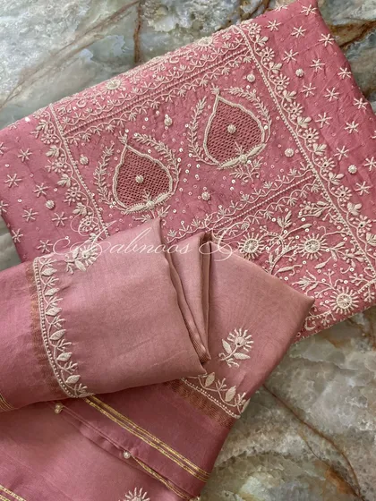 A folded view of the suit, perfect for appreciating the density of the embroidery.