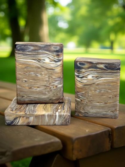 This woodgrain-patterned soap looks right at home in nature. The intricate layers are created by carefully pouring different shades of brown, black, and white soap batter.