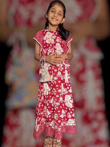 Our vibrant red floral dress, paired with a handcrafted crochet bag. This outfit is crafted from the highest-quality cotton to ensure she stays cool and comfortable all day long.