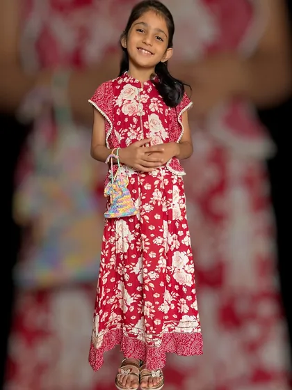 Our vibrant red floral dress, paired with a handcrafted crochet bag. This outfit is crafted from the highest-quality cotton to ensure she stays cool and comfortable all day long.
