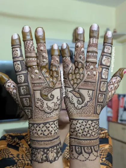 A heavy back-hand design with prominent peacock motifs. The intricate feather details and surrounding patterns make this a standout piece.