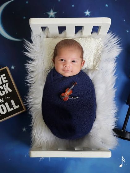 For the music lovers, a "Rock 'n' Roll" theme is a fantastic choice. This little rockstar is ready for the stage, complete with a miniature microphone and a starry night backdrop.