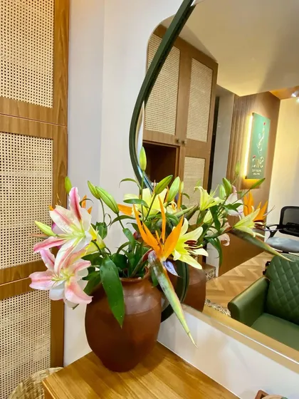 Fresh flowers always brighten the space. A beautiful arrangement of lilies and birds of paradise adds a touch of natural elegance to our salon.