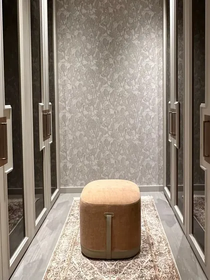 This walk-in wardrobe is a sanctuary of style and functionality, designed with a soothing neutral color palette. Exquisite mirror work embellishes the space, reflecting light and adding depth, while the layout offers practical organization with timeless elegance.