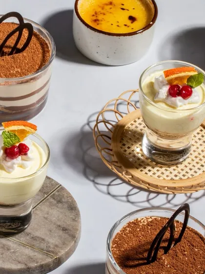 A beautiful overhead shot of our dessert selection, showcasing the variety and artistry of our sweet treats, from creamy Tiramisu to fruity Vanilla Mascarpone Bliss.