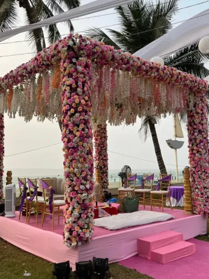 For clients who love flowers, we designed this mandap completely covered in pink and purple blooms. The structure includes hanging floral strings, creating a dense, fragrant, and visually stunning space for the wedding rituals.