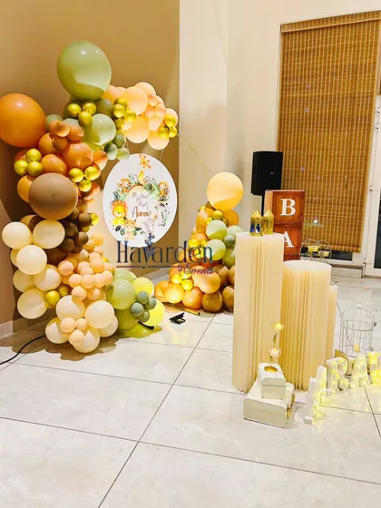 Another angle of the elegant jungle-themed setup, showing the circular backdrop and custom-wrapped pedestals.