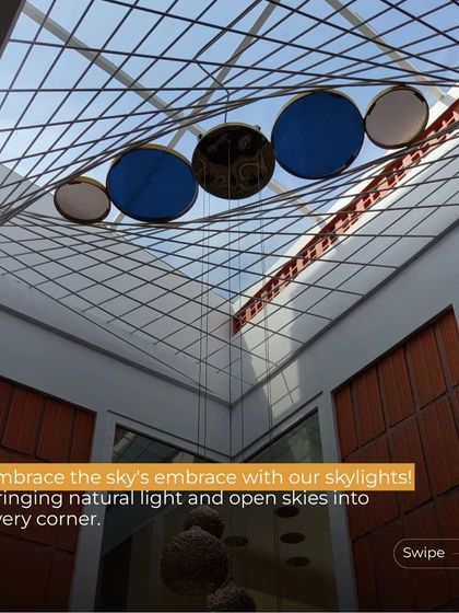 An artistic skylight installation that acts as a centerpiece for the room. The suspended colored discs interact with the sunlight, creating a constantly changing light installation below.
