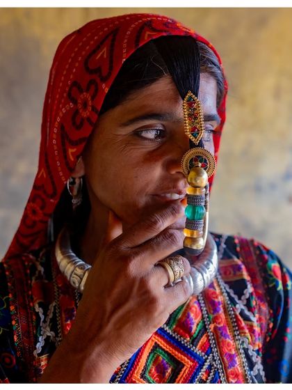 A close-up portrait of a Dhaneta Jat woman from Kutch, Gujarat. The focus is on her traditional, large nose ring, a symbol of her marital status and cultural identity.