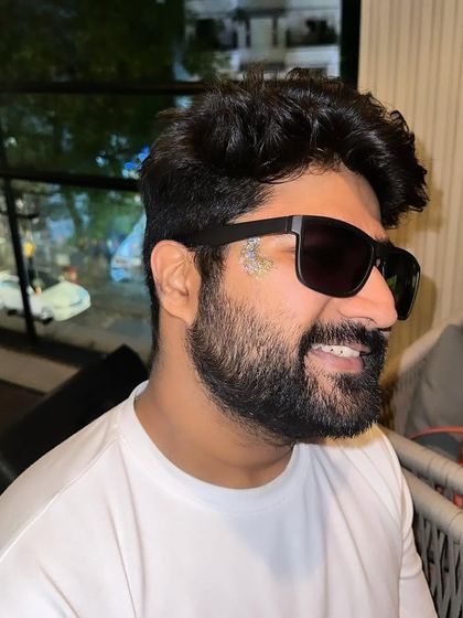 The same client now with sunglasses on. The glitter still peeks out, adding a bit of unexpected sparkle to his look.