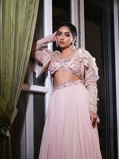 A full shot of the model, her unique outfit and dramatic makeup creating a memorable look.