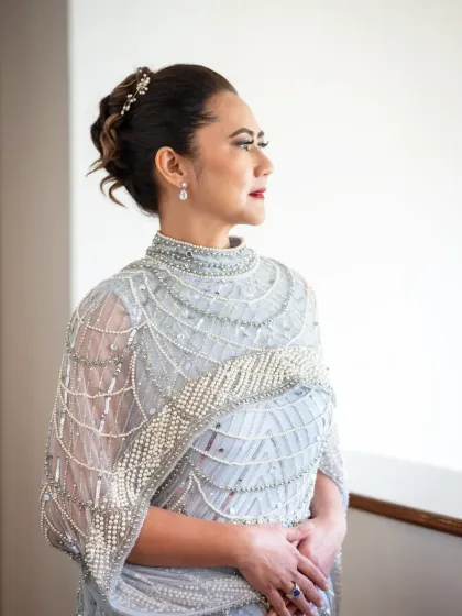 An elegant portrait by the window. This shot from a silver anniversary celebration has a classic, graceful feel.