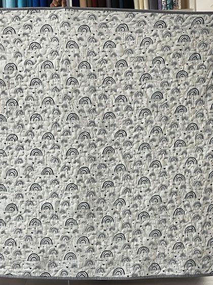 The back of the quilt, featuring a cute rainbow-print fabric.