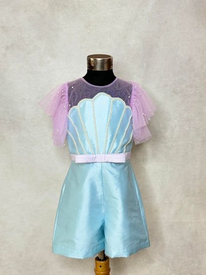 The playsuit portion of our mermaid-themed outfit. The shimmering blue fabric and seashell detail make it a complete look on its own, perfect for a play-area birthday party.