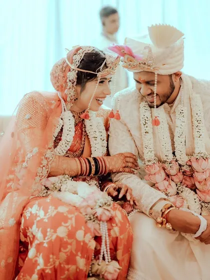 A candid moment of laughter during the ceremony. Soft glam, fresh florals, and all the bridal magic.