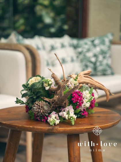 A tablescape detail from the 'Garden of Gaia' event, featuring driftwood and succulents.