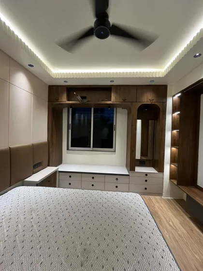 Another angle of the Sanpada master bedroom, showcasing the window-side seating with built-in drawers and a dedicated vanity unit. My goal is always to maximize the utility of every square foot.