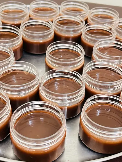 A fresh batch of my rich, chocolate-hued cream, likely the Hand & Foot Nourishing Cream, ready for jarring. The deep color comes from the pure, potent Ayurvedic herbs I use.