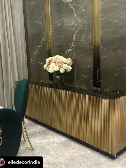 Featured in Elle Decor, this opulent sideboard is one of our signature pieces. It features a black marble top and a facade of vertical polished gold metal tubes, creating a dramatic and luxurious statement.