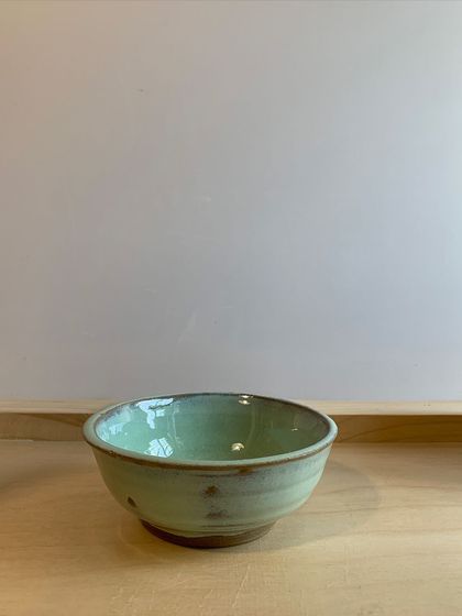 A simple, elegant bowl with a soft mint-green glaze. Perfect for your morning cereal or a comforting soup.