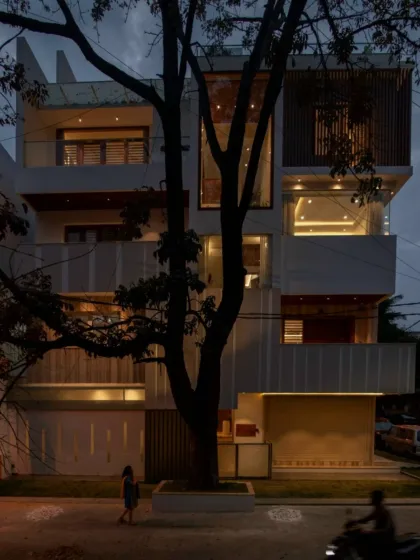 Where architecture captivates passersby. This home's complex and layered facade creates a dynamic presence on the street, coexisting with the mature tree that stands before it.