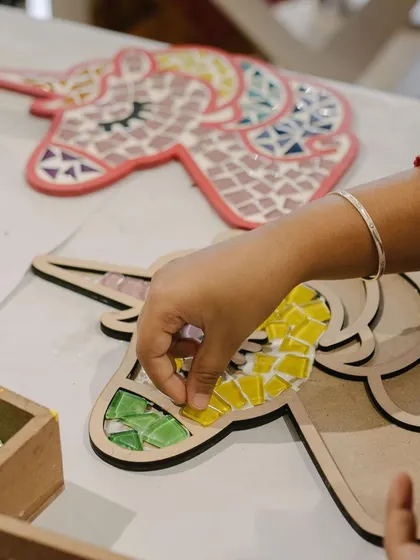 There's something so magical about mosaic art. This close-up shows one of our young artists carefully placing tiles on a unicorn base. Our mosaic kits come with pre-cut wooden shapes and colourful tiles, making it a perfect hands-on activity for an afternoon of fun.