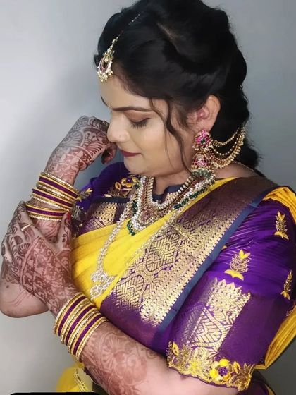 Pratima looking elegant for her cousin's wedding. The makeup is classic, with defined eyes and a deep lip color that matches her saree.