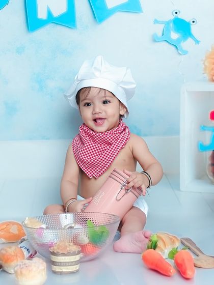 A happy chef in the making. This little one is having a great time playing with all the kitchen props in this fun and interactive session.