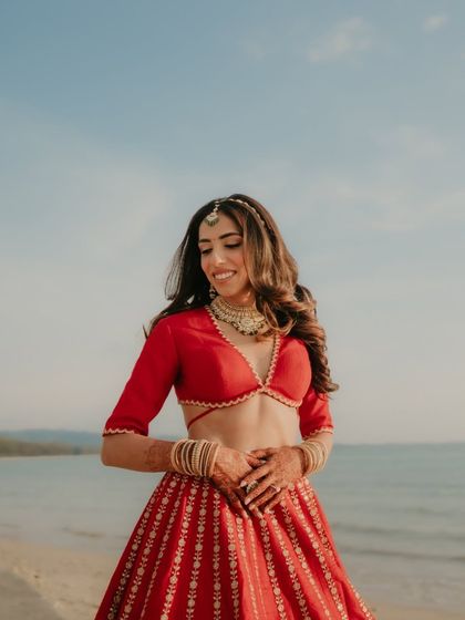 A close-up of my happy bride, her hair and makeup perfectly complementing the beach setting.