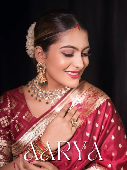 A close-up portrait with the bride's name, "Aarya," elegantly written. This is a beautiful way to personalize your bridal album.