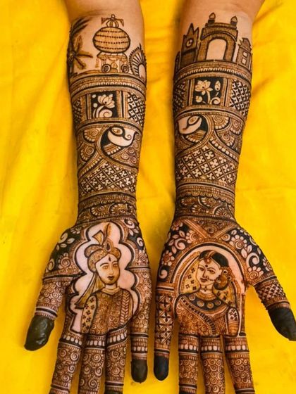 A full view of the bridal mehendi that combines portraits with cityscapes. This shows how different personal elements can be woven together into a cohesive and stunning design that covers both hands and arms.