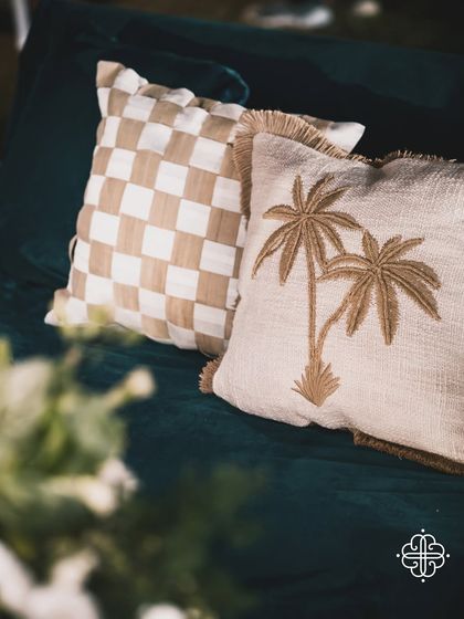 Custom-designed cushions with palm tree embroidery, perfect for the beachside lounge area.