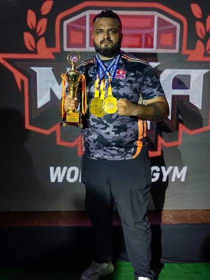 As a coach, their victory is my victory. Holding the team trophy and medals from the Hades MMA championship.